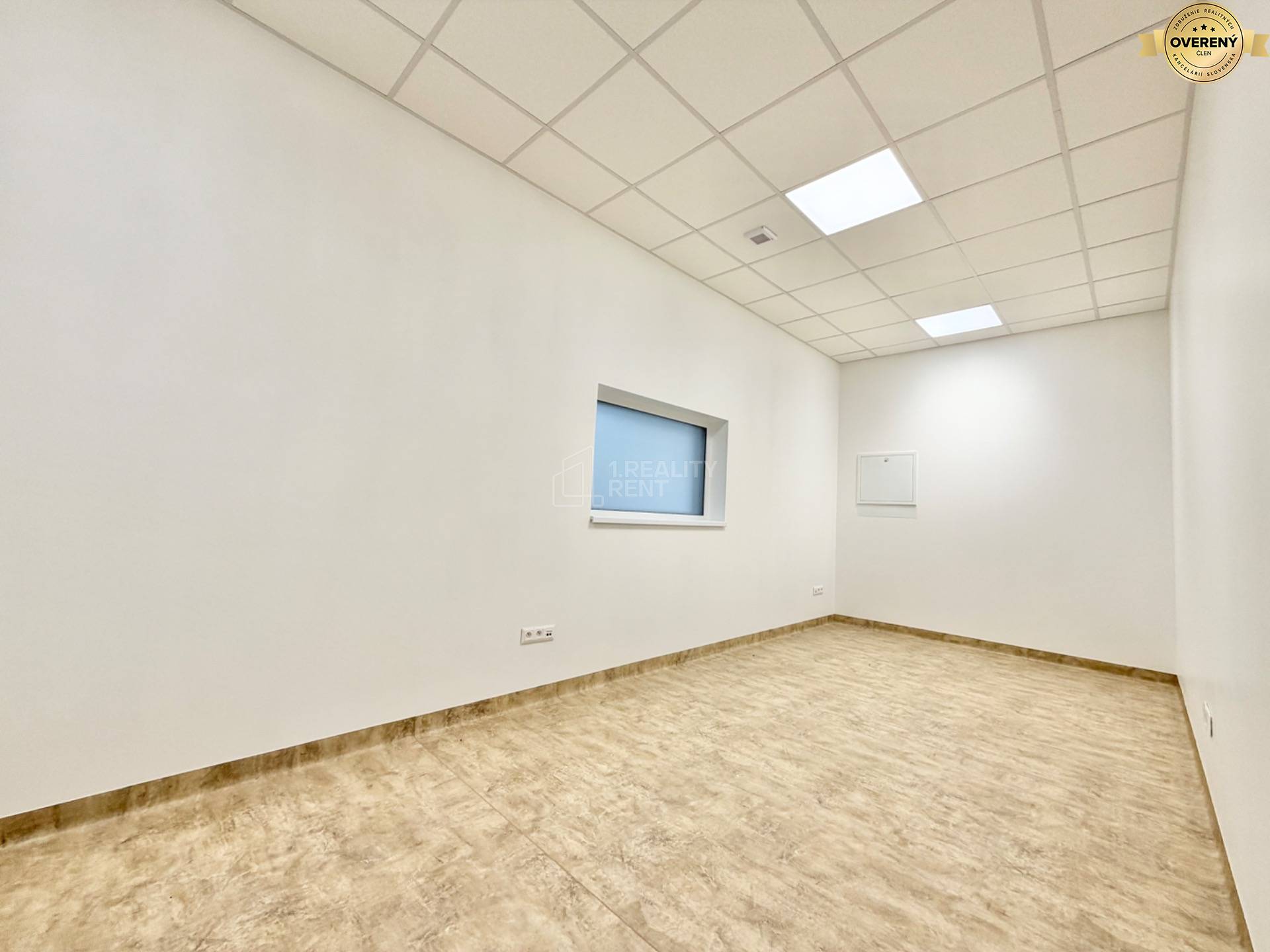 Biela kancelária s podlahou s dreveným dekorom, svetlý interiér, podhľad s osvetlením.